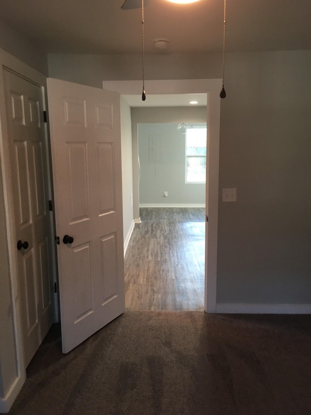 hallway with dark hardwood / wood-style flooring