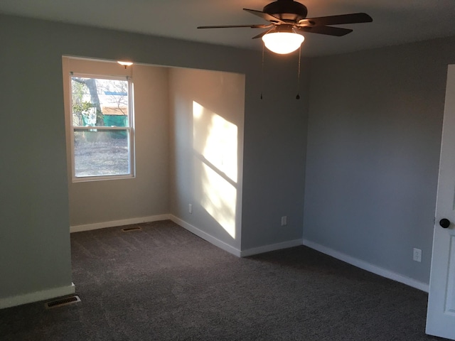 carpeted spare room featuring ceiling fan