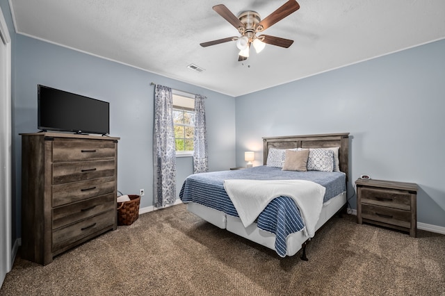 carpeted bedroom featuring a textured ceiling and ceiling fan