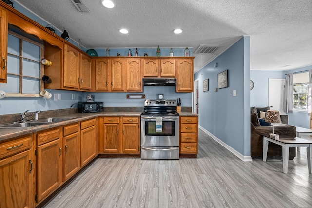 kitchen with a textured ceiling, sink, stainless steel electric range, and light hardwood / wood-style flooring