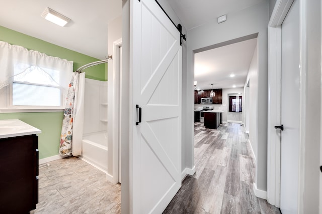 bathroom with shower / bath combo with shower curtain, vanity, and hardwood / wood-style flooring