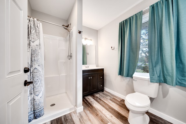 bathroom with a shower with curtain, vanity, wood-type flooring, and toilet