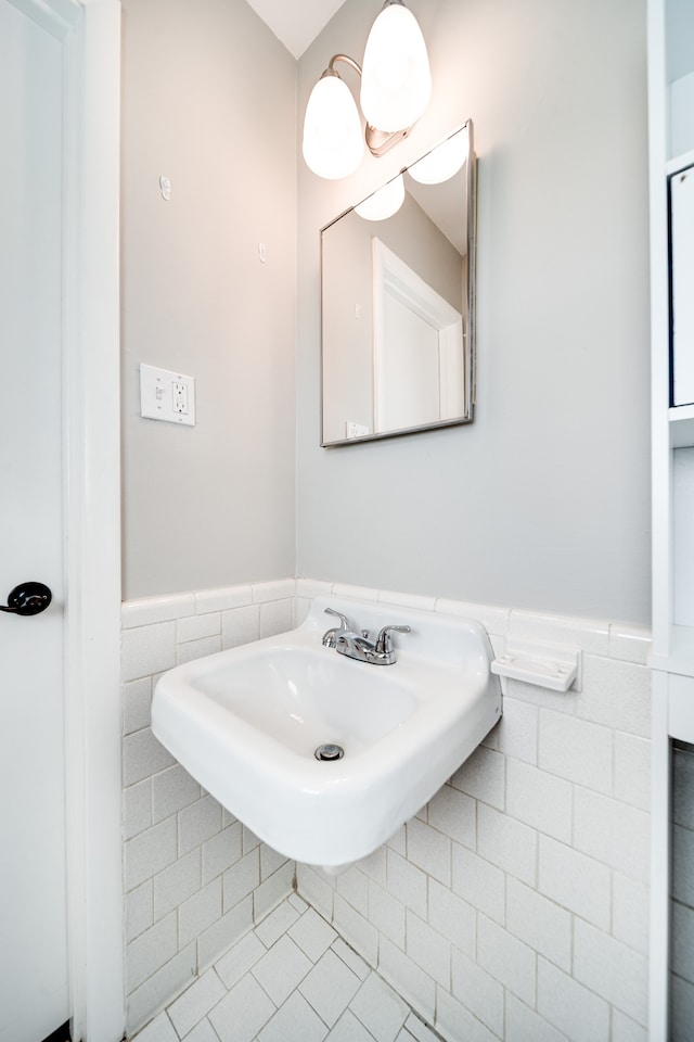 bathroom with tile patterned floors and tile walls