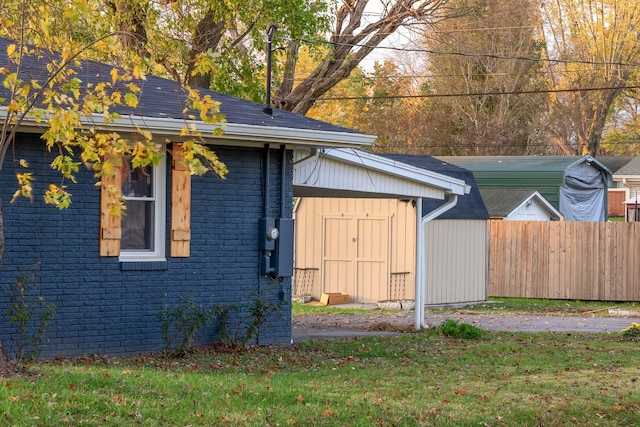 view of home's exterior featuring a yard and a storage shed