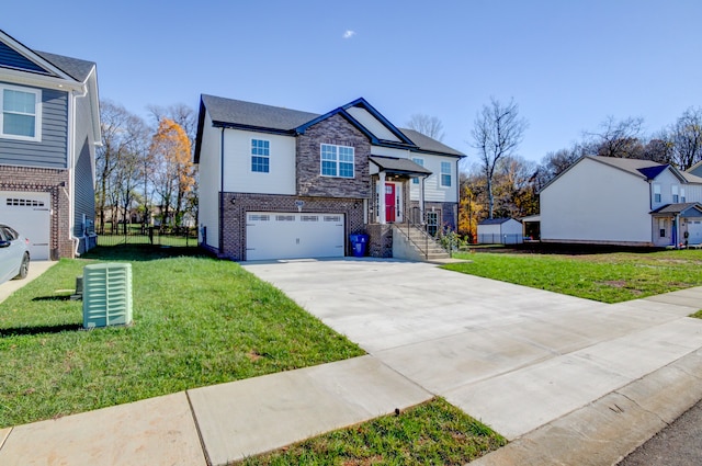 view of front of home with a front yard and a garage