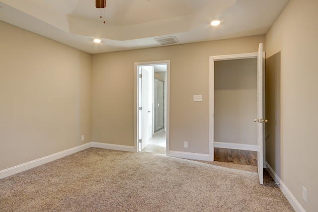 unfurnished bedroom featuring light carpet and ceiling fan