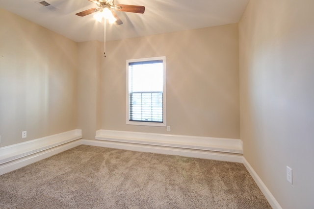 carpeted spare room with ceiling fan