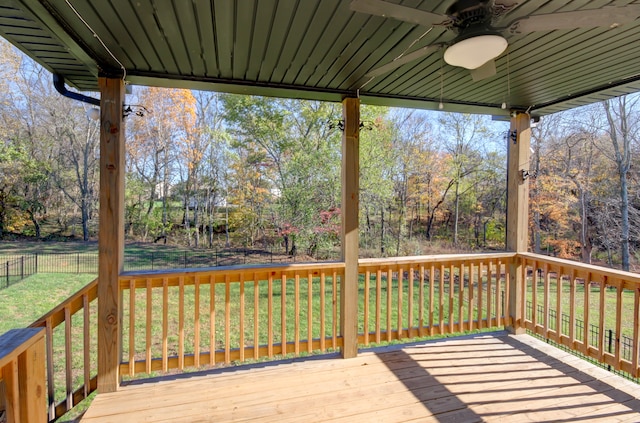 wooden deck featuring ceiling fan and a lawn