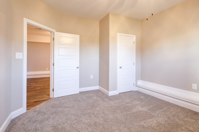 unfurnished bedroom featuring carpet flooring and a closet