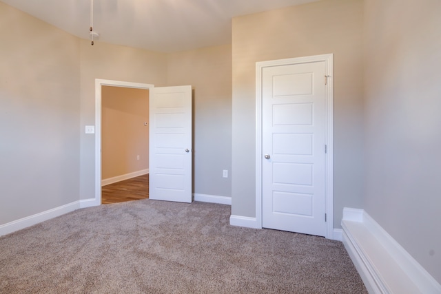 unfurnished bedroom featuring light carpet