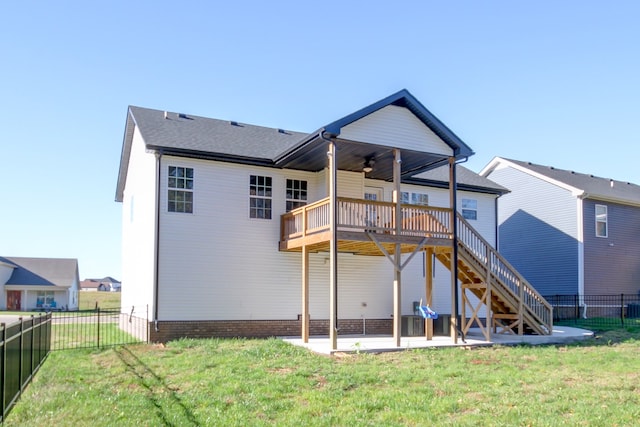 rear view of house featuring a lawn, ceiling fan, a patio, and a wooden deck