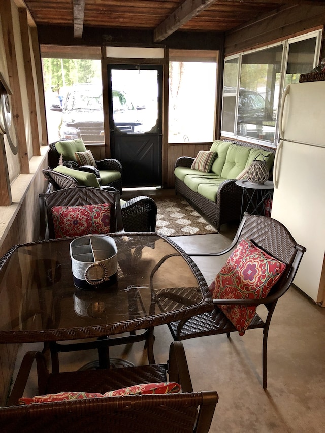 sunroom with beam ceiling and wooden ceiling