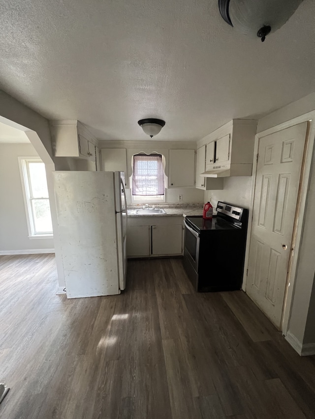 kitchen featuring white cabinetry, dark hardwood / wood-style floors, white refrigerator, a textured ceiling, and stainless steel range with electric stovetop