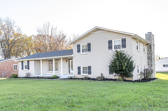 tri-level home with a front yard and a porch