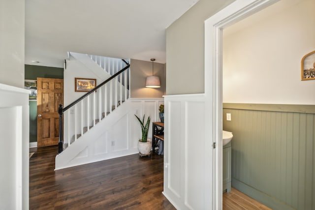 stairs featuring hardwood / wood-style flooring