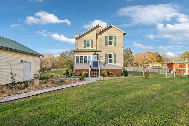 front facade with a sunroom and a front lawn