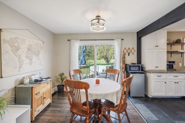 dining area featuring dark wood-type flooring