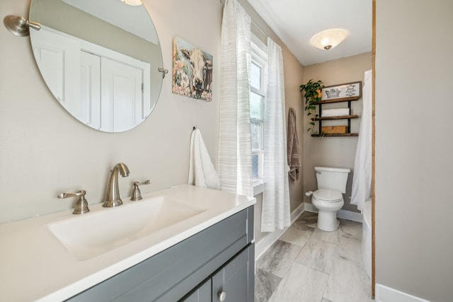 bathroom featuring vanity and toilet