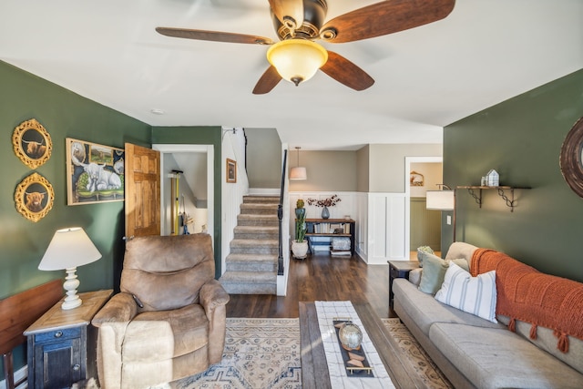 living room featuring ceiling fan and dark hardwood / wood-style flooring