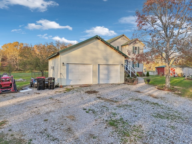 view of side of property with a garage and an outdoor structure