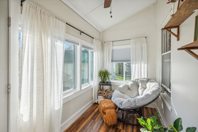 sunroom / solarium with ceiling fan, a healthy amount of sunlight, and vaulted ceiling