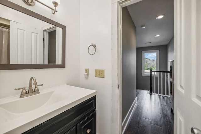 bathroom with hardwood / wood-style floors and vanity