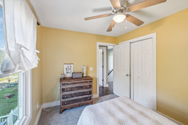 carpeted bedroom with a closet and ceiling fan