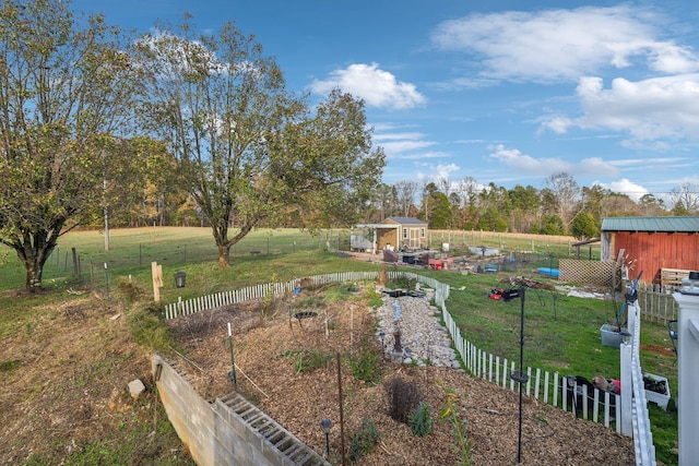 view of yard with an outbuilding and a rural view