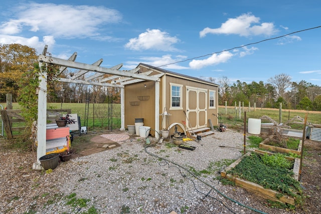 view of outbuilding with a pergola