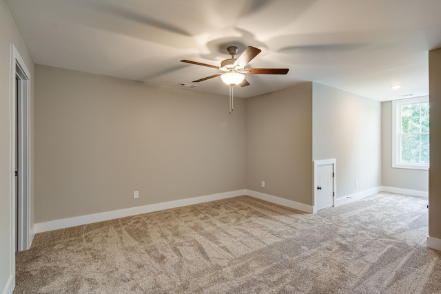 unfurnished room featuring light carpet and ceiling fan