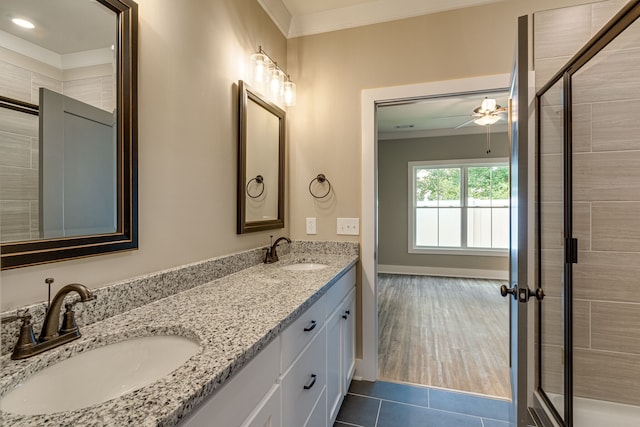 bathroom with vanity, crown molding, hardwood / wood-style flooring, ceiling fan, and walk in shower