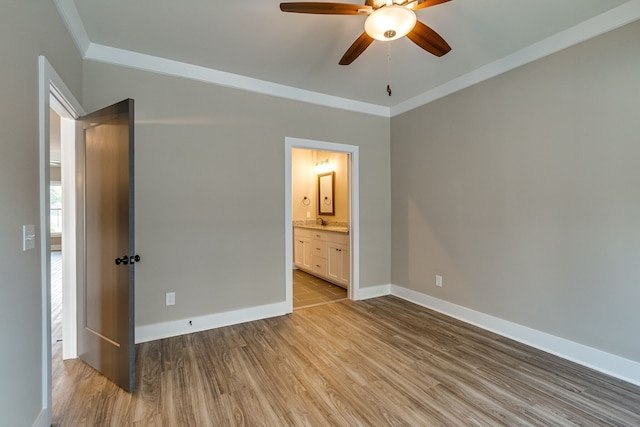 unfurnished bedroom featuring connected bathroom, ceiling fan, light hardwood / wood-style flooring, and crown molding