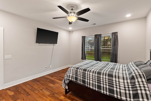 bedroom with ceiling fan and dark hardwood / wood-style flooring