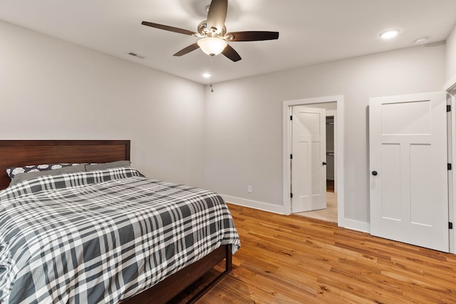 bedroom with ceiling fan and light hardwood / wood-style flooring