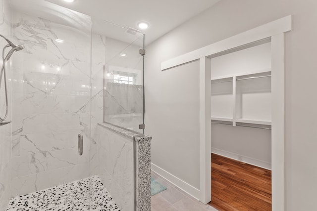 bathroom featuring hardwood / wood-style floors and walk in shower