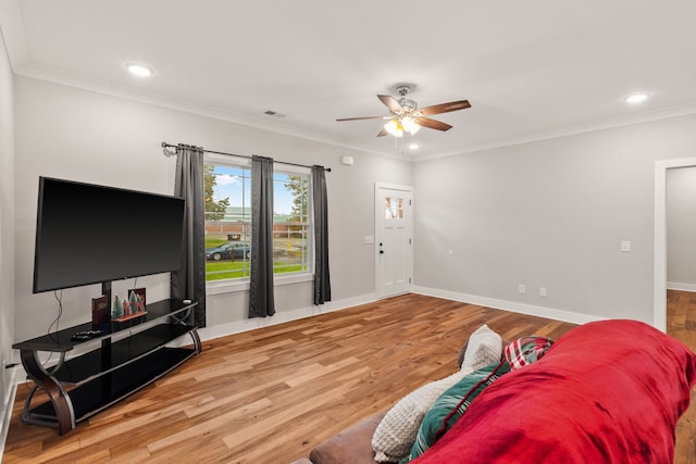 living room with ceiling fan, ornamental molding, and hardwood / wood-style flooring