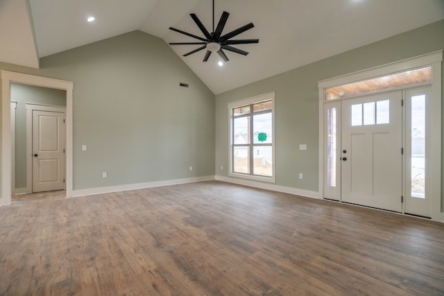 foyer entrance with ceiling fan, high vaulted ceiling, and light wood-type flooring