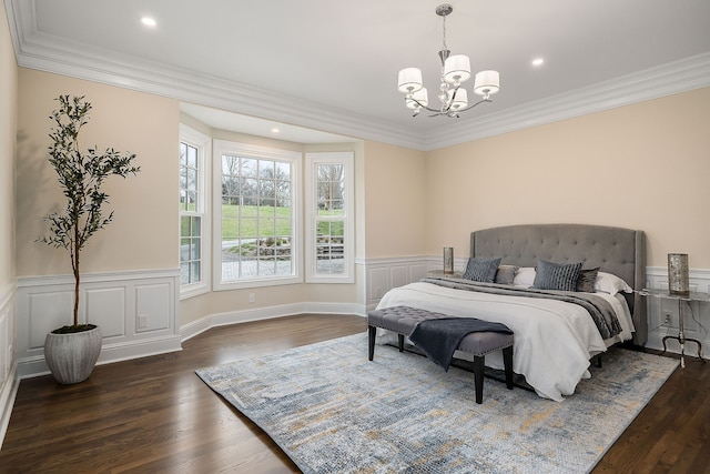 bedroom featuring a chandelier, dark hardwood / wood-style floors, and ornamental molding