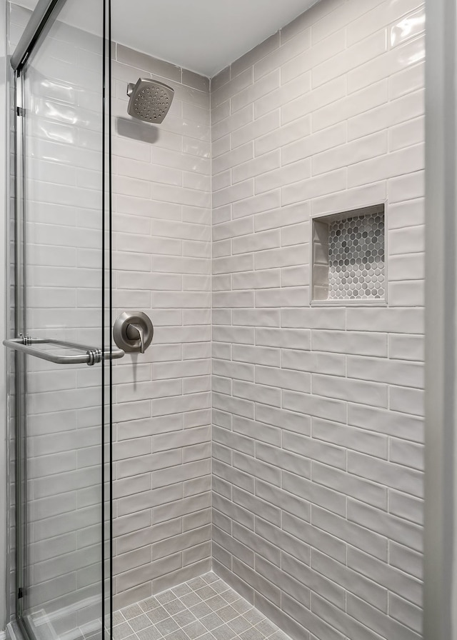 bathroom featuring a shower with door