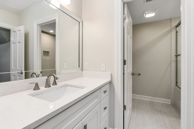 bathroom featuring vanity and combined bath / shower with glass door