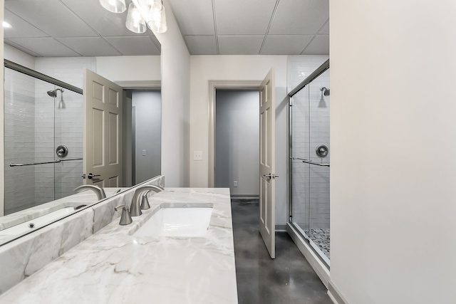 bathroom featuring concrete flooring, vanity, and a shower with door