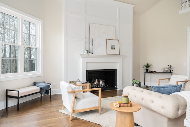 living room featuring wood-type flooring and vaulted ceiling