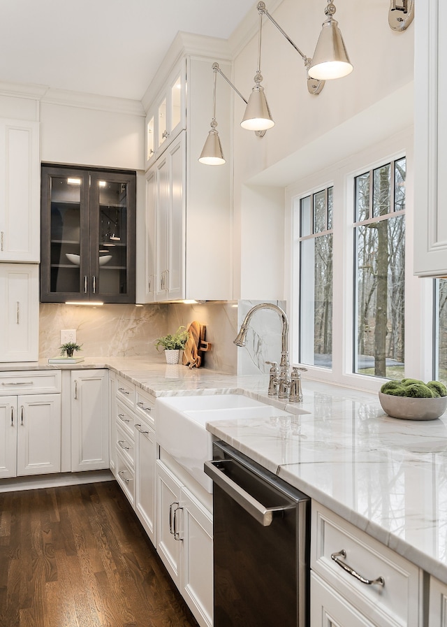 kitchen featuring dishwasher, white cabinetry, and hanging light fixtures