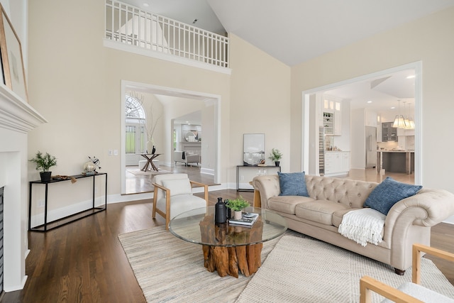 living room with wood-type flooring and high vaulted ceiling