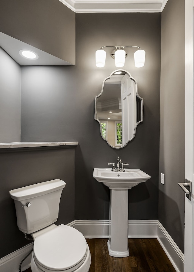 bathroom featuring hardwood / wood-style floors, toilet, and crown molding