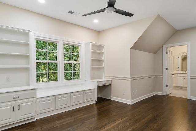 unfurnished bedroom with ceiling fan, dark wood-type flooring, and connected bathroom