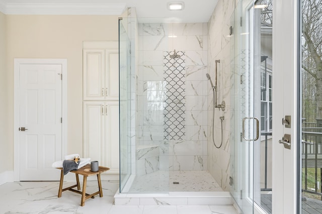 bathroom featuring crown molding and a shower with shower door