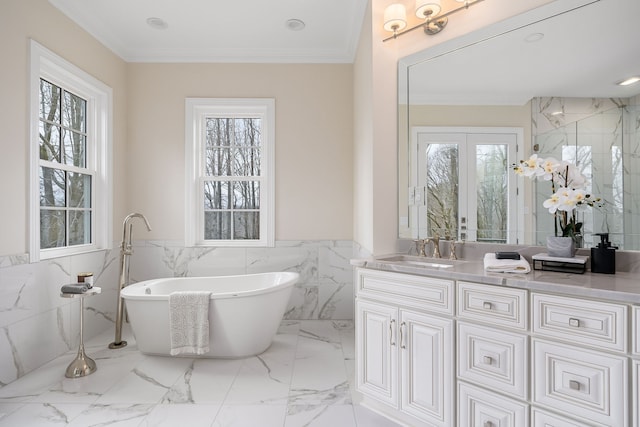 bathroom with a wealth of natural light, crown molding, tile walls, and a washtub