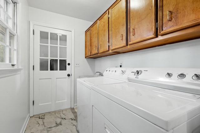 washroom featuring washing machine and dryer, sink, and cabinets