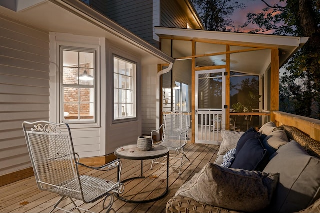 deck at dusk with an outdoor living space